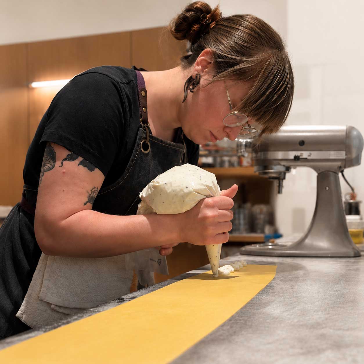 Pastry Chef Paige Trout piping pastry in the PLT Bakery kitchen